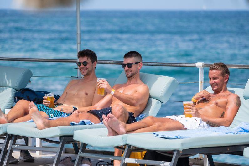Boys sunbathing with beer