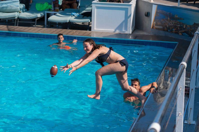 Girl catching ball in pool