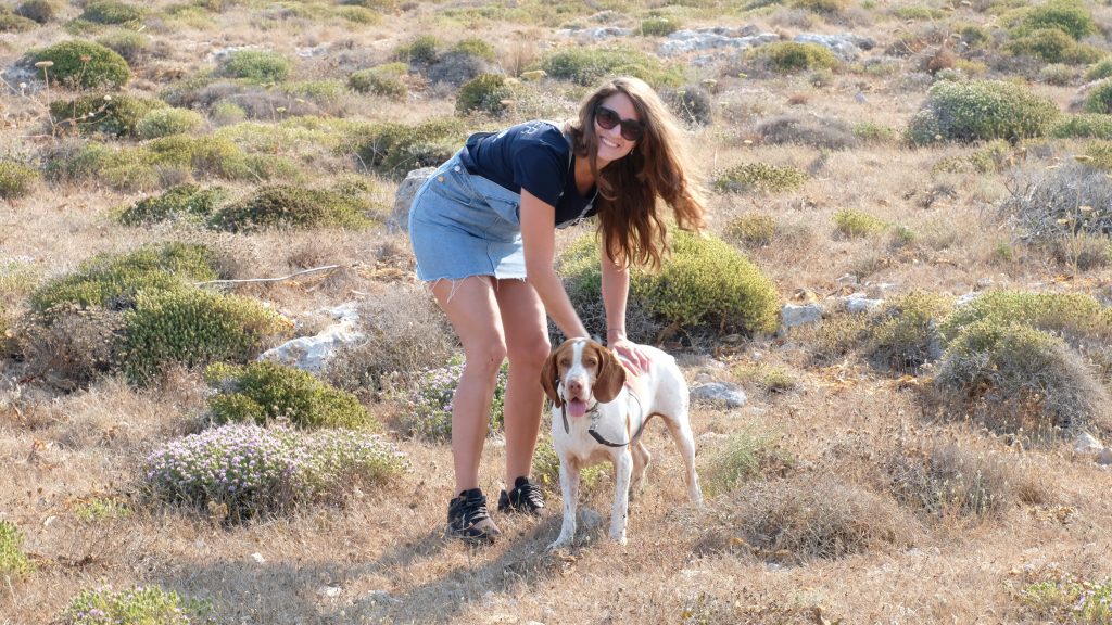 A woman with a dog in a field