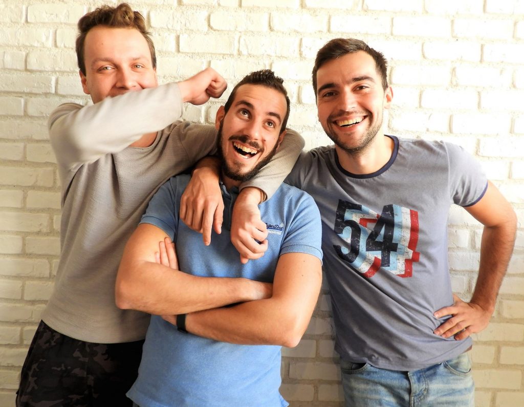 Three men laughing and smiling