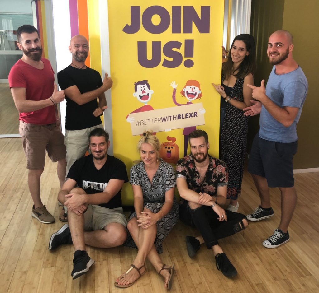 A group of people next to a sign that says "Join Us"