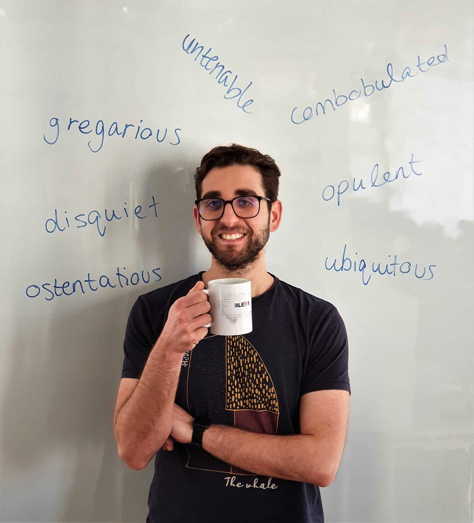 Man holding mug with words around head