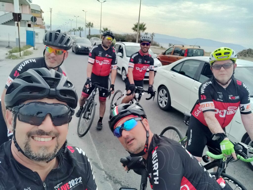 A group of cyclists posing for the camera with their bikes